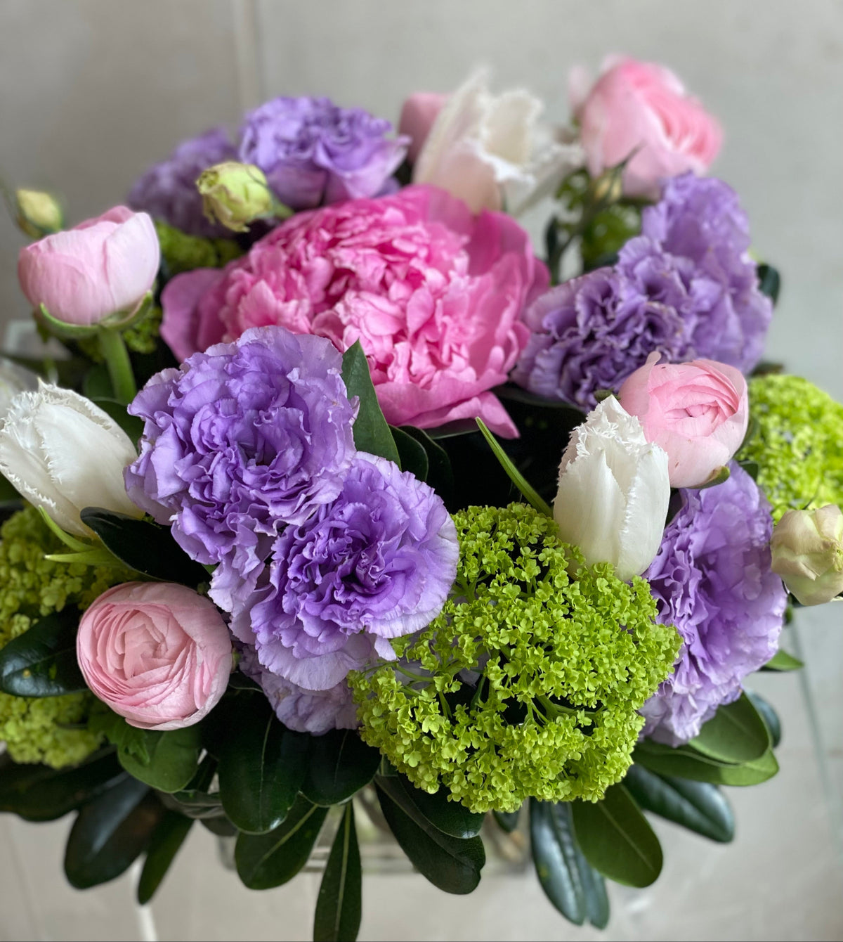 Bold seasonal floral arrangement in vibrant colors with a curated mix of premium blooms.