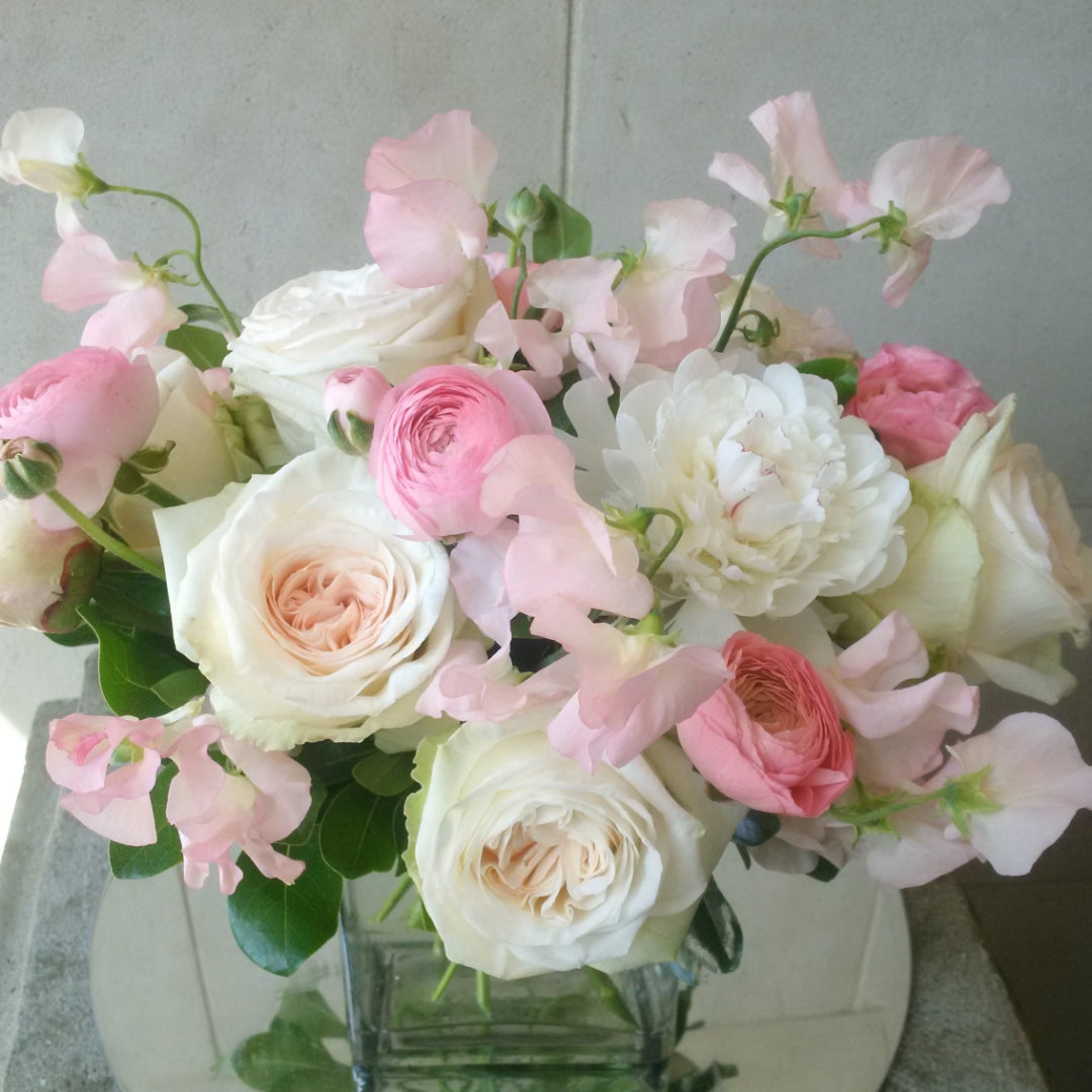 Custom floral arrangement created with a curated selection of fresh seasonal flowers and greenery.