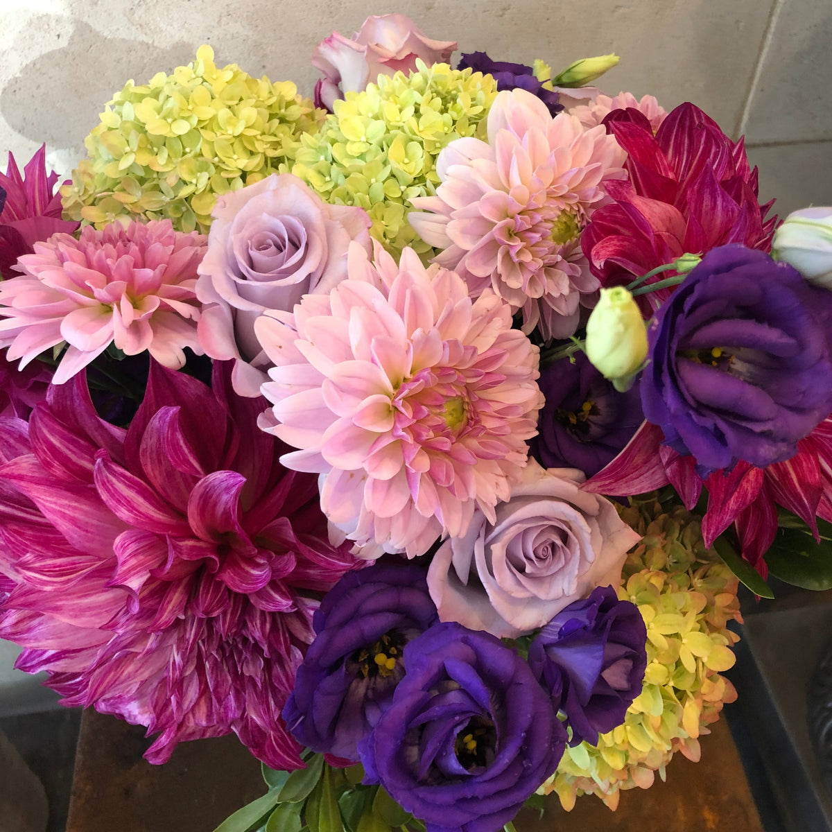 Custom floral arrangement created with a curated selection of fresh seasonal flowers and greenery.