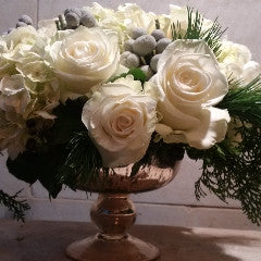 Custom floral arrangement created with a curated selection of fresh seasonal flowers and greenery.