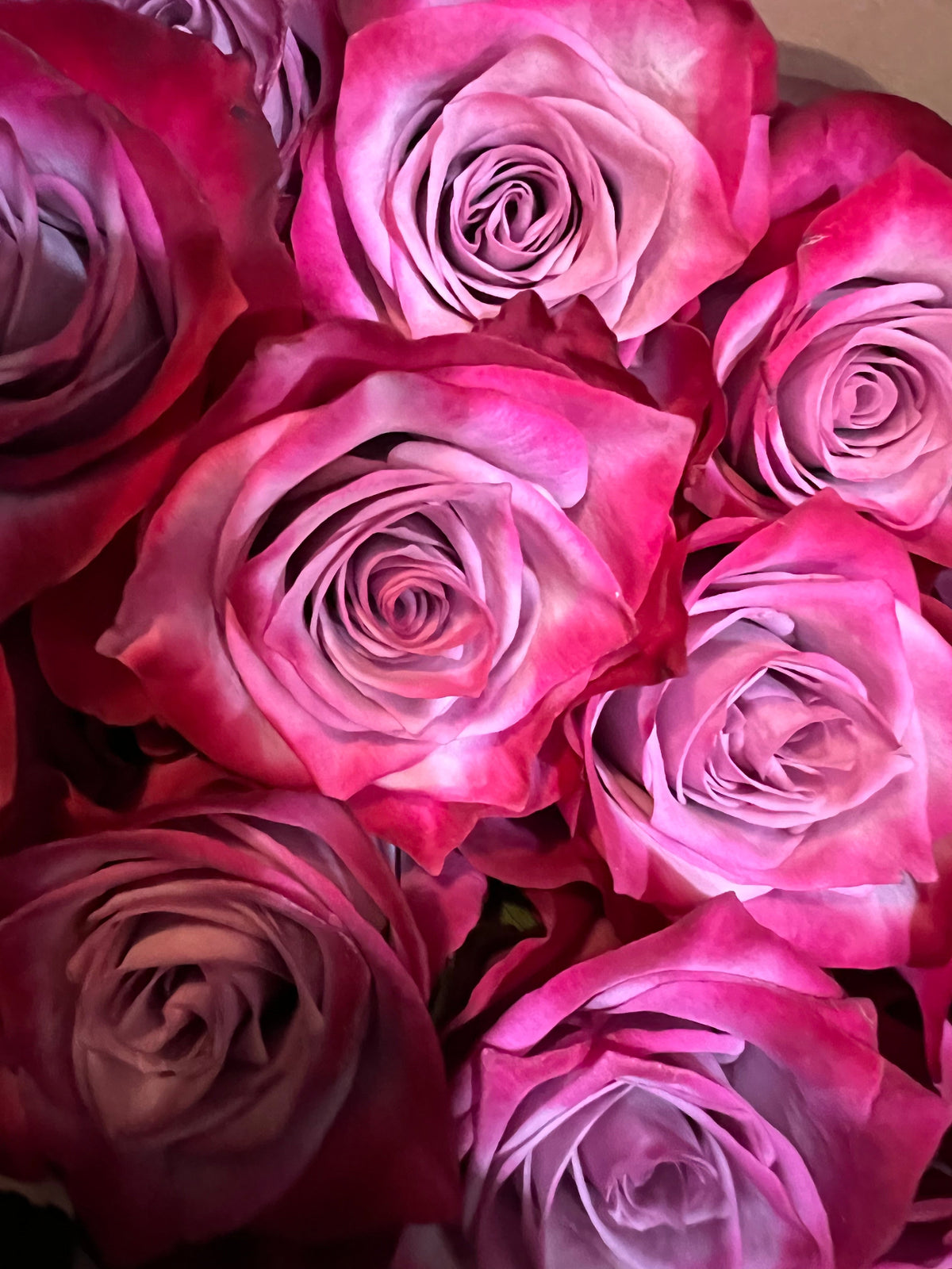 Dozen roses with seasonal accent flowers and fresh greenery, available as a hand-tied bouquet or vase arrangement.