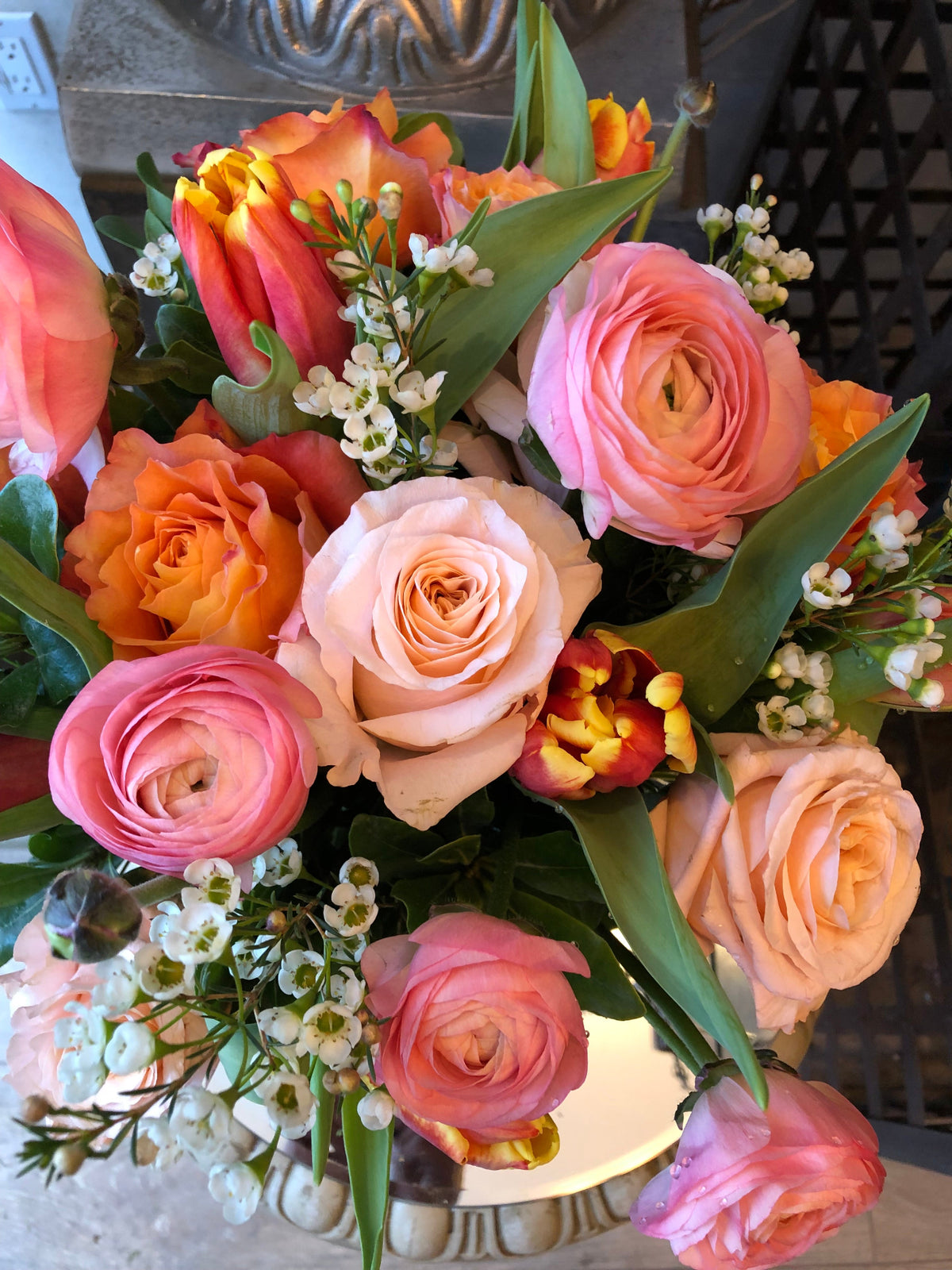 Custom floral arrangement created with a curated selection of fresh seasonal flowers and greenery.