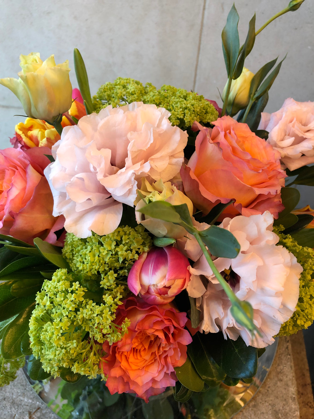 Custom floral arrangement created with a curated selection of fresh seasonal flowers and greenery.