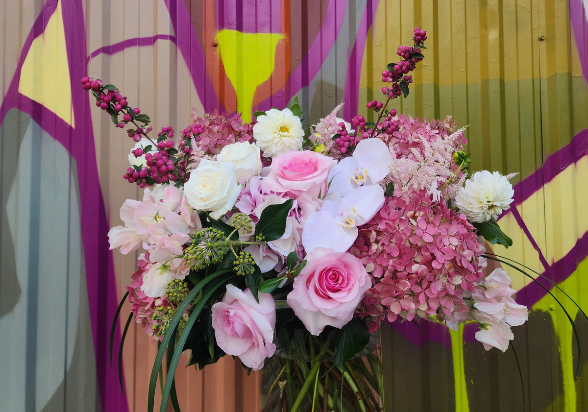 Custom floral arrangement created with a curated selection of fresh seasonal flowers and greenery.