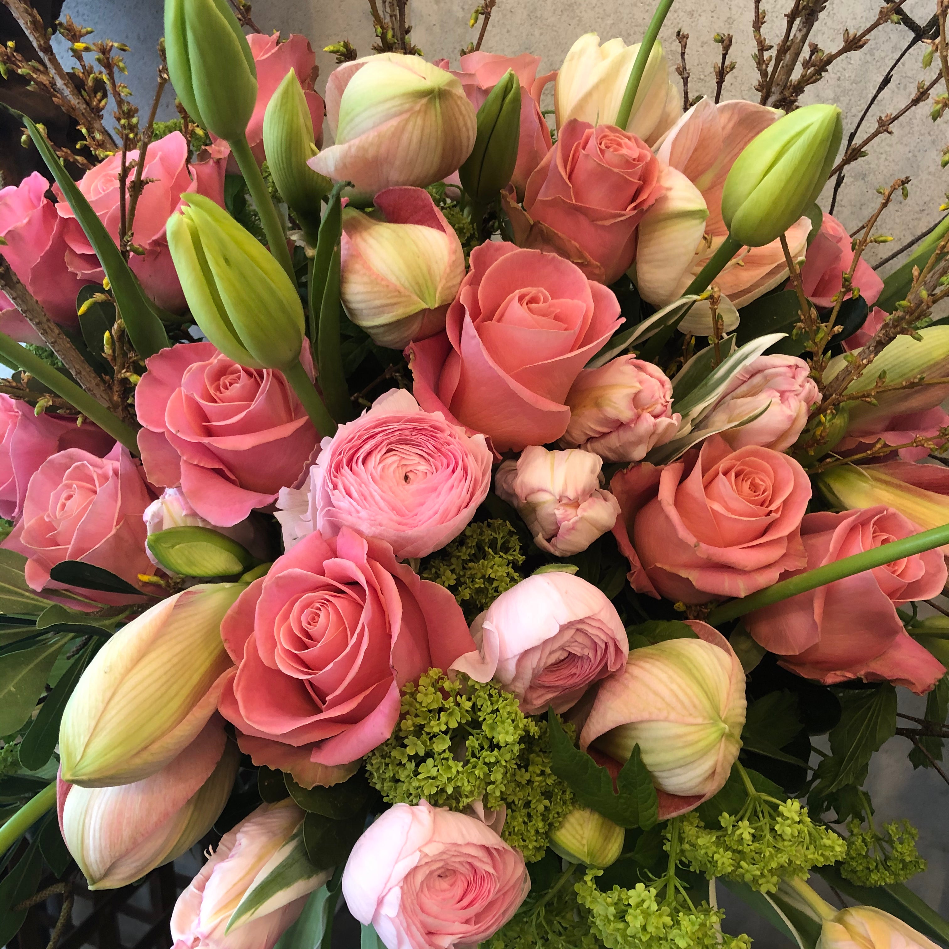 Custom floral arrangement created with a curated selection of fresh seasonal flowers and greenery.