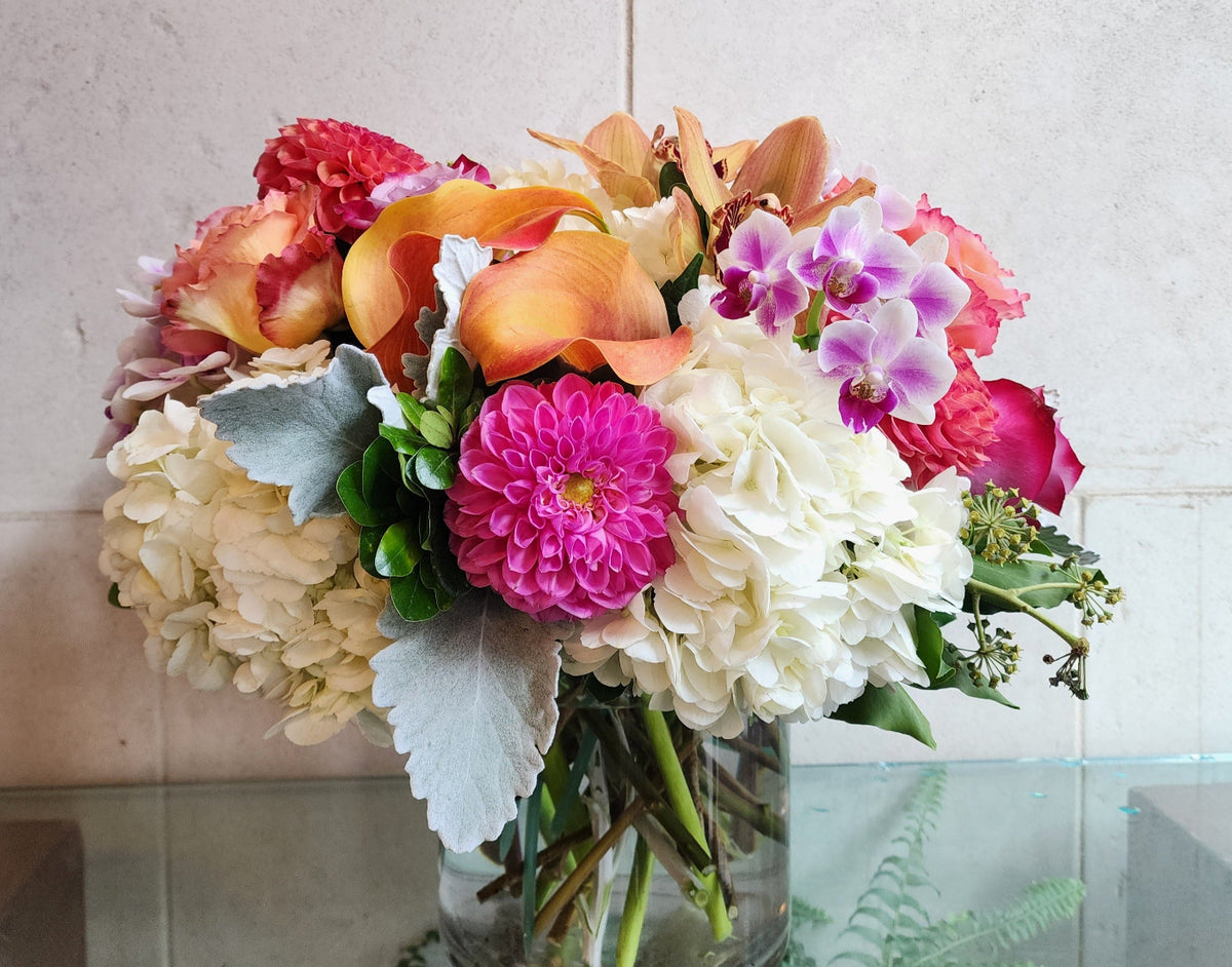 Big and Bold Vase Arrangement with colorful seasonal flowers in a clear glass vase.