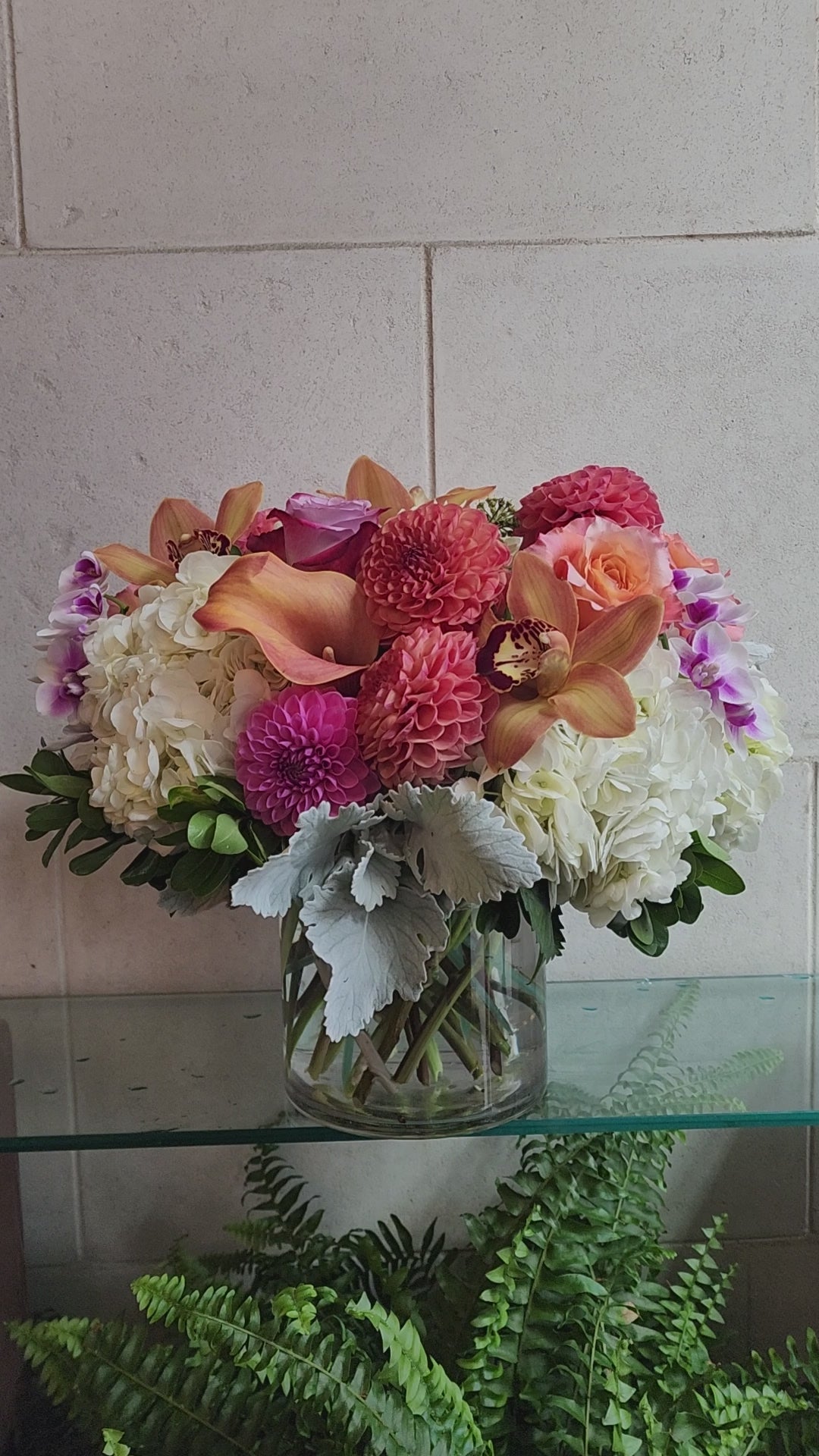 Big and Bold Vase Arrangement with colorful seasonal flowers in a clear glass vase.
